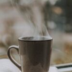 photo of coffee mug on top of book